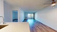 This contemporary 590 square foot apartment in Newport Beach offers a harmonious blend of style and functionality. The space features a single bedroom measuring 190 square feet, complemented by one bathroom. The open-concept layout seamlessly integrates the kitchen and living room, maximizing the use of space.

The kitchen is a standout feature, boasting sleek cabinetry in light wood tones and contrasting white lower cabinets. Stainless steel appliances, including a refrigerator and electric range, add a modern touch. The kitchen island, topped with a light-colored countertop, provides additional workspace and casual dining options.

Throughout the apartment, warm-toned wood flooring creates a cohesive and inviting atmosphere. The living area is bathed in natural light from a large sliding glass door, offering views of the surroundings and access to outdoor space. An air conditioning unit ensures year-round comfort.

The bathroom, while compact, is efficiently designed with a shower/tub combination and clean, white fixtures. The bedroom, spacious at 190 square feet, features ample room for a queen-sized bed and additional furniture.

This apartment combines contemporary design with practical living, making it an ideal residence for those seeking a modern lifestyle in the desirable Newport Beach area.