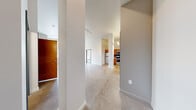 Located in Pittsburgh's Mt. Washington neighborhood, this two-bedroom, two-bathroom residence offers a thoughtfully designed single-floor layout with a clean, modern aesthetic. Polished concrete floors extend throughout the main living areas, lending an industrial-chic character that is both durable and visually striking. Structural columns punctuate the open living space, adding architectural interest while naturally defining zones within the layout.

The kitchen is a standout feature, outfitted with warm-toned wood cabinetry, a teal mosaic tile backsplash, stainless steel appliances including a refrigerator, dishwasher, and range, and generous counter space — all illuminated by pendant lighting above.

The spacious primary bedroom offers ample natural light through a pair of large windows, polished concrete flooring, and access to a dedicated closet. The second bedroom features plush carpet and its own closet with wire shelving for organized storage. Both closets provide practical, well-configured storage solutions.

The bathrooms are finished with warm wood vanities, white countertops, recessed lighting, and walk-in showers equipped with grab bars. The overall ambiance throughout the residence is clean, bright, and contemporary, with neutral walls and modern fixtures creating a cohesive, move-in-ready environment.