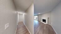 Located at 14820 Redmond Way in Redmond, WA, this single-floor, 2-bedroom, 2-bathroom residence offers a well-organized layout with a comfortable, modern aesthetic throughout. The living room serves as the heart of the home, anchored by a classic white brick corner fireplace and sliding glass doors that open to a private balcony, allowing natural light to fill the space. Hardwood-style flooring runs throughout, lending a clean and cohesive look to every room. The galley-style kitchen is efficiently designed, featuring white upper cabinetry, wood-toned lower cabinets, quartz countertops, a subway tile backsplash, a stainless steel sink, and stainless steel appliances including a refrigerator, range, and dishwasher. A dedicated hallway connects the bedrooms and bathrooms, providing a clear separation between living and sleeping areas. The primary bedroom offers generous proportions with a built-in closet featuring sliding panel doors and shelving. The second bedroom includes a window with natural light and its own closet access. Both bathrooms are well-appointed, with one featuring a walk-in shower and the other a full tub-shower combination, each with updated vanities and modern fixtures. A dedicated closet provides additional storage throughout this practical and well-maintained Redmond residence.