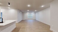 Located at 283 Pane Rd in Newington, Connecticut, this thoughtfully designed one-bedroom, one-bathroom unit offers a clean, modern aesthetic across a single floor. Light wood-tone flooring flows seamlessly throughout every room, creating a cohesive and inviting atmosphere.

The open-concept kitchen and living area serves as the heart of the unit. The kitchen is outfitted with textured dark wood cabinetry, crisp white quartz countertops, a classic subway tile backsplash, and a full suite of stainless steel appliances including a refrigerator, range, microwave, and dishwasher. A peninsula with an undermount sink adds additional prep space and separates the kitchen from the generous living area, which is illuminated by recessed lighting and features a wall-mounted mini-split HVAC unit.

The bedroom is a quiet, well-proportioned retreat with a window offering outdoor views, a dedicated mini-split unit for personalized climate control, and ample closet storage with double doors. The bathroom is clean and functional, featuring a tub-shower combo, a dark wood vanity with a white countertop, and matte black hardware accents that complement the unit's modern design language.

Throughout the space, white walls, recessed lighting, and minimalist trim work contribute to a bright, contemporary feel.