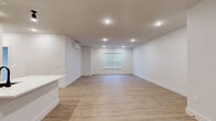 Located at 283 Pane Rd in Newington, Connecticut, this thoughtfully designed one-bedroom, one-bathroom unit offers a clean, modern aesthetic across a single floor. Light wood-tone flooring flows seamlessly throughout every room, creating a cohesive and inviting atmosphere.

The open-concept kitchen and living area serves as the heart of the unit. The kitchen is outfitted with textured dark wood cabinetry, crisp white quartz countertops, a classic subway tile backsplash, and a full suite of stainless steel appliances including a refrigerator, range, microwave, and dishwasher. A peninsula with an undermount sink adds additional prep space and separates the kitchen from the generous living area, which is illuminated by recessed lighting and features a wall-mounted mini-split HVAC unit.

The bedroom is a quiet, well-proportioned retreat with a window offering outdoor views, a dedicated mini-split unit for personalized climate control, and ample closet storage with double doors. The bathroom is clean and functional, featuring a tub-shower combo, a dark wood vanity with a white countertop, and matte black hardware accents that complement the unit's modern design language.

Throughout the space, white walls, recessed lighting, and minimalist trim work contribute to a bright, contemporary feel.
