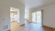 Located at 2404 Allen St. in Kelso, WA, this single-floor, 2-bedroom, 1-bathroom home offers a bright and functional layout with a clean, neutral aesthetic throughout. Light wood-style flooring extends across the main living areas, complementing the crisp white walls and creating an airy, cohesive feel.

The open living and dining area is generously sized, filled with natural light from large windows and a sliding glass door that opens directly onto a covered balcony — ideal for enjoying outdoor views of the surrounding greenery. The kitchen is efficiently designed in a U-shape, featuring white cabinetry with warm wood trim, white appliances including a refrigerator, range, and dishwasher, ample counter space, and overhead lighting.

Both bedrooms are well-proportioned, with the primary bedroom offering a spacious closet with sliding doors and a window overlooking the outdoors. The second bedroom also benefits from a large window framing tree views. The full bathroom includes a vanity with sink and a tub/shower combination, with a window providing natural light.

Additional highlights include six closets for extensive storage, a dedicated laundry area, an entrance, and a hallway connecting the spaces. The balcony, accessible via the living area, adds valuable outdoor space to this well-organized home.