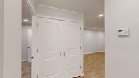 Located at 1000 Crystal Lake Circle in Macon, Georgia, this one-bedroom, one-bathroom unit offers a thoughtfully organized single-level layout across a comfortable footprint. The interior features light-toned luxury vinyl plank flooring throughout the main living areas, complemented by clean white walls and crown molding details that lend a polished finish.

The kitchen stands out as a clear highlight, showcasing white shaker-style cabinetry, granite countertops, a stainless steel range with overhead ventilation, and a distinctive teal glass tile backsplash that adds a touch of color and character. The dining area flows naturally from the kitchen, creating a cohesive space for everyday living.

The bedroom is generously proportioned, finished with plush carpeting and recessed lighting. Vertical blinds cover a sliding glass door that opens to a private balcony overlooking lush, mature trees—providing a serene outdoor retreat. A dedicated closet offers convenient storage.

The bathroom includes a full tub and shower combination with clean, neutral finishes. A separate laundry area houses a stacked washer and dryer unit, adding everyday convenience. The hallway connects all rooms efficiently, completing this well-appointed and move-in ready home.