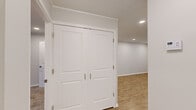 Located at 1000 Crystal Lake Circle in Macon, Georgia, this one-bedroom, one-bathroom unit offers a thoughtfully organized single-level layout across a comfortable footprint. The interior features light-toned luxury vinyl plank flooring throughout the main living areas, complemented by clean white walls and crown molding details that lend a polished finish.

The kitchen stands out as a clear highlight, showcasing white shaker-style cabinetry, granite countertops, a stainless steel range with overhead ventilation, and a distinctive teal glass tile backsplash that adds a touch of color and character. The dining area flows naturally from the kitchen, creating a cohesive space for everyday living.

The bedroom is generously proportioned, finished with plush carpeting and recessed lighting. Vertical blinds cover a sliding glass door that opens to a private balcony overlooking lush, mature trees—providing a serene outdoor retreat. A dedicated closet offers convenient storage.

The bathroom includes a full tub and shower combination with clean, neutral finishes. A separate laundry area houses a stacked washer and dryer unit, adding everyday convenience. The hallway connects all rooms efficiently, completing this well-appointed and move-in ready home.