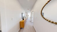 Located at 75 Willow Ct in Boston's Dorchester neighborhood, this thoughtfully designed 2-bedroom, 2-bathroom residence offers a modern aesthetic with clean lines and high-quality finishes throughout its single-floor layout. The open-concept living area is bright and welcoming, featuring light hardwood flooring, recessed lighting, and large windows that fill the space with natural light. The living room offers a comfortable, well-proportioned area that flows seamlessly into the dining space, where oversized windows frame neighborhood views and flood the room with sunlight. The kitchen is outfitted with light wood cabinetry, quartz countertops, a subway tile backsplash, and a full suite of stainless steel appliances, including a French door refrigerator. The primary bedroom is a serene retreat with ample space, natural light from a wide window, and light hardwood floors. The second bedroom mirrors the same bright, airy quality. Both bathrooms feature large-format tile flooring, wood-toned vanities, and matte black fixtures — one with a soaking tub and tiled surround. The overall design is cohesive and contemporary, combining neutral tones, modern hardware, and abundant natural light to create a comfortable and refined living environment.