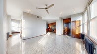 Located in the heart of downtown Tulsa at 427 S Boston Ave, this one-bedroom, one-bathroom residence offers a thoughtfully designed layout across a single floor. Polished terrazzo floors flow seamlessly throughout the entire unit, reflecting natural light and lending a sleek, timeless character to the space.

The open-concept main living area combines the living room, dining room, and kitchen into one cohesive zone. A ceiling fan overhead and large double-hung windows in the living area fill the space with abundant natural light, while a classic cast-iron radiator beneath the windows adds a nod to the building's architectural heritage. The kitchen is well-appointed with rich cherry wood cabinetry featuring frosted glass inserts, dark granite countertops, a full suite of stainless steel appliances — including a refrigerator, range, microwave, and dishwasher — a tile backsplash, and a mobile kitchen island with a granite top for added prep and dining flexibility.

The bedroom is generously proportioned, offering ample space and access to two closets. The bathroom continues the terrazzo flooring and features a dark granite vanity with cherry wood cabinetry. Additional conveniences include an in-unit laundry area and a hallway connecting the private spaces. Solid wood doors with brass hardware are found throughout, reinforcing the unit's warm, upscale urban aesthetic.
