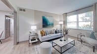This 650 square foot home in Nashville, Tennessee offers a harmonious blend of comfort and style within its compact footprint. The space efficiently accommodates two bedrooms, including a spacious 130 square foot primary bedroom, along with one full bathroom. The open-concept design maximizes the living area, seamlessly connecting the kitchen, dining room, and living room.

The interior showcases a modern aesthetic with a cohesive color palette of whites, grays, and soothing blues. The kitchen features crisp white cabinetry, stainless steel appliances, and granite countertops, creating a bright and functional cooking space. The living room is adorned with contemporary furnishings, including a plush sofa and sleek coffee table, complemented by carefully curated artwork that adds visual interest.

Both bedrooms offer ample space and are decorated with a mix of calming neutrals and pops of color, creating serene retreats. The bathroom continues the modern theme with a vanity topped with granite, a large mirror, and a shower/tub combination adorned with patterned curtains.

Throughout the home, light wood-look flooring enhances the sense of space and contributes to the overall bright and airy ambiance. Strategic lighting fixtures and natural light from windows further illuminate the interiors. The thoughtful design and decor choices make this compact home feel spacious and inviting, perfect for comfortable modern living.