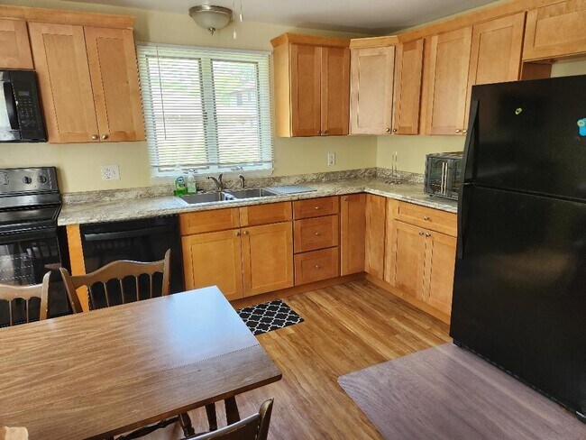 Kitchen with all appliances, table and chairs. - 7226 Witmer Rd