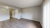 Located at 504 Bethel Rd in Morganton, NC, this two-story, 2-bedroom, 2-bathroom home offers a practical and comfortable layout spread evenly across two floors. The main floor features a living room with warm gray-toned walls and durable hardwood-style flooring that flows throughout, creating a cohesive and clean aesthetic. The kitchen is well-appointed with rich, dark wood cabinetry, light countertops, a double stainless steel sink, and a window that brings in natural light and outdoor views — complemented by a built-in dishwasher for added convenience. Upstairs, both bedrooms are generously proportioned with the same hardwood-style flooring, neutral gray walls, and textured ceilings. The primary bedroom offers ample space and is well-lit by multiple windows with views of the surrounding greenery. Both bedrooms include closets with sliding or hinged doors for practical storage. The two bathrooms are clean and functional, with one featuring a full tub-shower combo, a single vanity with white countertop, and warm wood cabinetry. A connecting hallway ties the layout together efficiently. The home's overall ambiance is bright, neutral, and move-in ready, suited for comfortable everyday living.