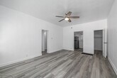 Located at 123 E Windsor Rd in Glendale, CA, this single-floor, one-bedroom, one-bathroom unit offers an efficient and thoughtfully laid-out living space. Light wood-style flooring runs seamlessly throughout, lending a clean, cohesive aesthetic to every room. The living area is bright and open, featuring white walls, a ceiling fan with lighting, and natural light filtering in through a window with views of surrounding greenery — creating an airy, welcoming atmosphere. The space flows naturally into the bedroom, which also features a ceiling fan, a closet with louvered doors, and a window that brings in additional natural light. The kitchen is a standout feature, equipped with rich dark wood cabinetry, a classic white subway tile backsplash, and a full suite of stainless steel appliances including a gas range, over-the-range microwave, and refrigerator. A single sink with ample counter space completes the functional layout. The bathroom is finished in crisp white, featuring a full bathtub with a handheld showerhead and a window that allows natural light and a glimpse of the outdoors. Two closets provide practical storage solutions throughout the unit. The overall design is clean, minimal, and move-in ready.