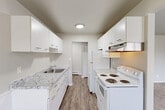 Located at 2716 Packard St in Ann Arbor, MI, this well-appointed one-bedroom, one-bathroom unit offers a thoughtfully organized single-floor layout. The galley-style kitchen is a standout feature, boasting white cabinetry with modern hardware, granite-style countertops, a stainless steel sink, and white appliances including a range and refrigerator. Wood-look flooring runs throughout the kitchen and connects seamlessly to the dining area, which includes wainscoting, a ceiling fan, and a window overlooking the exterior. The living room provides a comfortable, open feel with neutral carpeting and easy access to the rest of the unit. The bedroom offers a cozy retreat with soft carpet, a large window that fills the room with natural light, and access to a closet. Four closets throughout the unit provide exceptional storage. The bathroom is clean and functional, featuring wood-look flooring, wainscoting, a full tub-shower combo, toilet, and a white vanity with storage. A dedicated hallway and entrance area contribute to the unit's organized flow. Baseboard heating is present throughout, ensuring year-round comfort in this practical and neatly finished Ann Arbor residence.