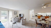 Located at 10 Lucas Ln in Voorhees, NJ, this well-appointed two-bedroom, one-bathroom residence offers a thoughtfully designed single-floor layout. The open-concept living and dining area serves as the heart of the home, featuring plush wall-to-wall carpeting, neutral toned walls, and abundant natural light streaming through a sliding glass door that leads directly to a private patio. The living area provides generous space for comfortable seating arrangements, while the adjacent dining area includes a ceiling fan and connects seamlessly to the kitchen. The kitchen features hardwood-style flooring, white cabinetry, dark granite-style countertops, and a full suite of appliances, with a pass-through bar that opens to the dining space. Both bedrooms are carpeted and well-lit by large windows, offering a calm and restful atmosphere. The primary bedroom includes a spacious double-door closet. The full bathroom is clean and functional, featuring a tub-shower combination. A dedicated laundry area adds everyday convenience, and three closets throughout the home ensure excellent storage. The entrance and hallway connect all areas of the home efficiently, creating a cohesive and practical floor plan throughout.