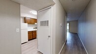 Located at 910 E 61st St S in Tulsa, Oklahoma, this two-bedroom, one-bathroom unit offers a practical and comfortable layout across a single floor. The living room serves as the heart of the home, featuring light-toned luxury vinyl plank flooring, a ceiling fan with light fixture, a textured ceiling, and a striking dark-brick wood-burning fireplace. A sliding glass door floods the space with natural light and provides direct access to an outdoor patio area. The kitchen connects openly to the living area and is outfitted with warm wood-toned cabinetry, light countertops, a range, dishwasher, and refrigerator — all set on matching LVP flooring. A pass-through window between the kitchen and living space enhances the open feel. A central hallway connects the main living areas to the two bedrooms, each carpeted for comfort with neutral wall tones and textured ceilings. The primary bedroom includes an adjacent closet. The full bathroom features a tub/shower combination and light flooring. A dedicated closet provides additional storage. The overall aesthetic is clean and neutral, offering a functional canvas throughout.