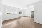Located at 2360 Weston Rd in Toronto's Weston neighbourhood, this thoughtfully laid-out one-bedroom, one-bathroom unit offers a clean, modern aesthetic across its single floor. Light wood laminate flooring runs seamlessly throughout, complementing the crisp white walls and creating a bright, cohesive atmosphere.

The open-concept living and kitchen area forms the heart of the unit. The kitchen is well-appointed with white cabinetry, a classic subway tile backsplash, dark countertops, and a full suite of stainless steel appliances including a refrigerator, stove, and built-in microwave. A window in the living area admits natural light and provides street views, while baseboard heating ensures year-round comfort.

The bedroom is a well-proportioned, private retreat featuring a wide sliding double-door closet for ample storage, a roller blind-fitted window with natural light, and a baseboard heater. Its clean lines and neutral palette keep the space feeling open and versatile.

The bathroom is finished with classic white subway tile surrounding a full soaking tub and shower, delivering a timeless and easy-to-maintain aesthetic.

A connecting hallway ties the layout together efficiently. Overall, the unit presents a fresh, move-in-ready space with consistent modern finishes throughout.