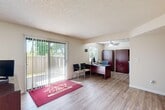 Located at 9309 Bocina Ln in Atascadero, CA, this single-story leasing office is a well-organized and functional space designed to provide a professional and welcoming environment. The layout encompasses two offices, a kitchen, a bathroom, and a connecting hallway, all situated on one floor.

The main reception office is bright and open, featuring light wood-look flooring and large sliding glass doors with vertical blinds that flood the room with natural light and offer views of the surrounding greenery. A ceiling fan adds comfort, and the space accommodates a reception desk and guest seating, creating an inviting atmosphere for visitors.

A secondary, more private office is carpeted and features a window with outdoor views, providing a quiet workspace suited for focused tasks or private consultations.

The kitchen is well-appointed with slate-blue shaker-style cabinetry, light countertops, stainless steel appliances including a refrigerator, range, and dishwasher, as well as recessed lighting and a ceiling fan overhead. The hallway connects the key areas of the space and features light wood-look flooring, wall-mounted lighting, and a clean, neutral color palette. Throughout, textured ceilings and warm beige walls contribute to a consistent and professional aesthetic.