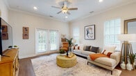 Located at 522 Fife Way in Myrtle Beach, South Carolina, this single-story home offers a thoughtfully designed layout with a bright, cohesive aesthetic. A wide hallway with warm hardwood-style flooring and crisp white walls serves as an inviting entry point, leading into the main living areas.

The living room is a standout space, featuring crown molding, recessed lighting, and a ceiling fan. Large windows and glass French doors flood the room with natural light while providing views of the outdoors, creating an airy and welcoming atmosphere.

Adjacent to the living room, the dining area benefits from abundant natural light through multiple windows and connects seamlessly to the kitchen. The kitchen is well-equipped with white shaker cabinetry, granite countertops, a subway tile backsplash, and stainless steel appliances, including a range, microwave, and dishwasher.

The bedrooms are comfortably sized with hardwood-style flooring and generous natural light from large windows. The bathrooms feature white cabinetry, granite countertops, and tub-shower combinations. Throughout the home, a neutral color palette and consistent finishes create a cohesive, polished living environment.