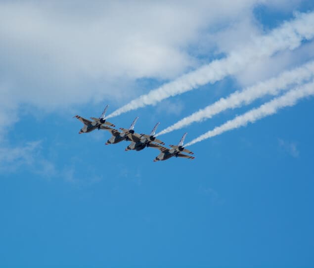 Planes fly overhead during an air show at Andrews AFB