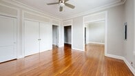 Located in Memphis's Park Terrace neighborhood, this 2-bedroom, 1-bathroom unit blends classic architectural character with thoughtful updates. The living room makes a strong first impression with rich hardwood floors, elegant crown molding, a ceiling fan, and abundant natural light streaming through large windows and French doors with transom panels — offering open views of the surrounding area. The layout connects seamlessly to the bedrooms, one of which features built-in white cabinetry with drawers and a vanity mirror, adding both charm and practical storage. Hardwood floors continue throughout the main living areas, reinforcing the warm, cohesive feel of the space. The galley-style kitchen has been updated with white shaker cabinets accented by matte black hardware, a stainless steel refrigerator and gas range, a modern arc-neck faucet, and neutral tile flooring — combining functionality with a clean, contemporary aesthetic. The bathroom retains its classic character with a black-and-white basketweave tile floor, a pedestal sink, a soaking tub, and a tall window that draws in natural light. A hallway connects the main rooms, contributing to an efficient and well-organized floor plan throughout this cozy yet characterful Memphis residence.