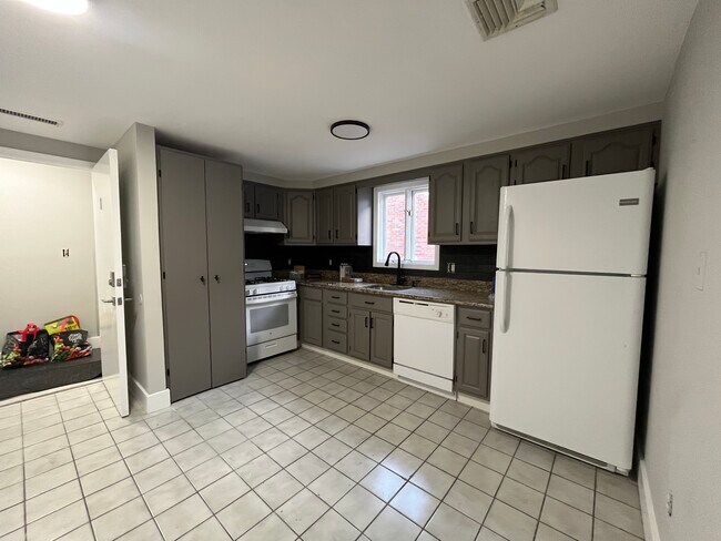 Kitchen featuring laundry closet, large pantry (opposite wall), granite countertops. - 255 Broad St