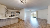 Located at 5968 Culzean Dr in Trotwood, Ohio, this well-appointed single-floor home offers three bedrooms and three bathrooms with a clean, modern aesthetic throughout. Light wood-tone luxury vinyl flooring flows seamlessly across the living spaces, complemented by crisp white walls and contemporary fixtures that create a bright, cohesive feel.

The open-concept kitchen and living area serves as the heart of the home. The kitchen is equipped with stainless steel appliances — including a range, microwave, refrigerator, and dishwasher — paired with two-tone cabinetry featuring warm wood lower cabinets and light gray uppers, all finished with matte black hardware. A quartz peninsula provides additional prep and seating space. The adjacent living room is generously sized and features a sliding glass door that opens to a private balcony overlooking a tree-lined view, inviting an abundance of natural light.

The spacious primary bedroom includes dual closets and a dedicated en-suite bathroom, offering a comfortable private retreat. The additional bedrooms are well-proportioned, each featuring closet storage and the same warm flooring. The bathrooms are finished with marble-look tile flooring, wood-toned vanities, matte black fixtures, and clean white tiled shower and tub surrounds, delivering a modern and polished look throughout.