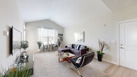Located at 7027 Park Mill Drive in Plain City, Ohio, this well-appointed one-bedroom, one-bathroom residence offers a thoughtfully designed single-floor layout. The open-concept living and dining area immediately impresses with dramatic vaulted ceilings that lend a sense of airy, expansive volume. Plush carpeting and neutral wall tones create a warm, inviting atmosphere, while large windows bathe the space in natural light. The kitchen is a functional highlight, featuring crisp white shaker-style cabinetry, granite countertops, stainless steel appliances, a breakfast bar peninsula, and light hardwood-style flooring that ties the cooking and dining areas together seamlessly. The bedroom is a comfortable retreat, offering carpeted floors, dual windows with soft drapery, a ceiling fan, and generous proportions. A large walk-in closet with wire shelving and hanging rods provides abundant storage. The bathroom continues the refined aesthetic with granite countertops, white cabinetry, hardwood-style flooring, and a bright window for natural ventilation. Additional conveniences include an in-unit laundry area and a private balcony, rounding out this well-equipped and efficiently organized residence.