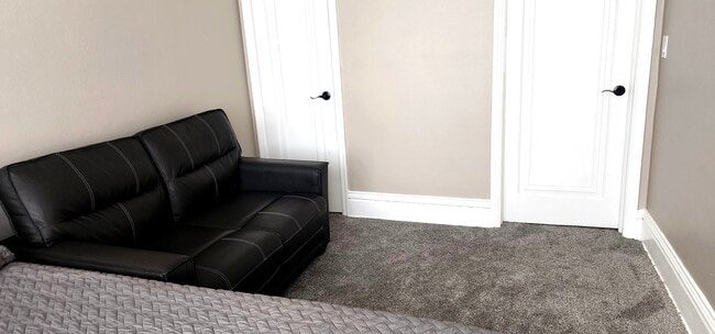 "Bedroom storage with modern loveseat & crisp neutral tones - 822 E 4th St