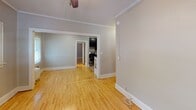 Located at 1105 W 28th St in Minneapolis, Minnesota, this single-floor unit blends classic architectural details with thoughtful updates. Hardwood floors run throughout the living spaces, lending warmth and continuity across each room. Crown molding accents the ceilings, adding a refined character consistent with the home's traditional roots.

The living areas are bright and open, with multiple windows dressed in white blinds that invite generous natural light. A ceiling fan in the main room provides both comfort and a classic aesthetic touch. The open flow between the living and adjoining rooms creates a spacious, connected feel, enhanced by clean white trim and neutral gray walls.

The kitchen stands out with dark espresso cabinetry reaching to the ceiling, granite countertops, a stainless steel double-basin sink, and stainless steel appliances including a refrigerator and range — offering a sharp contrast that gives the kitchen a contemporary, functional appeal.

Bedrooms continue the hardwood flooring theme, with ample wall space, natural light from multiple windows, and closet storage. The bathroom features a full tub and shower combination with white tile surround, chrome fixtures, and a window that provides natural ventilation and light.

The overall layout, as reflected in the floorplan, is well-organized and efficiently arranged, making this a practical and comfortable single-floor residence in a well-established Minneapolis neighborhood.