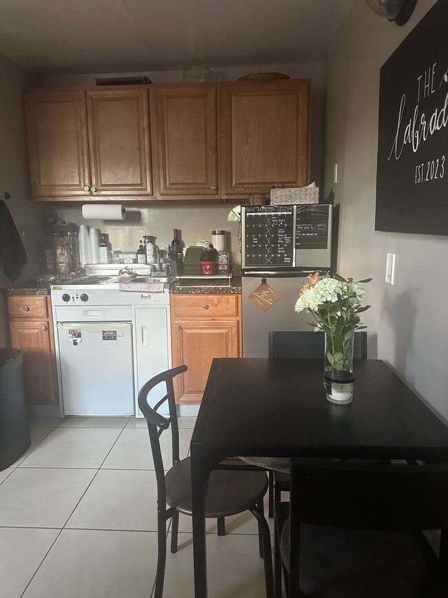 Kitchenette with plenty of storage and appliances included. - 11470 SW 5th Ter