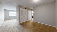 This well-designed single-story residence offers 990 square feet of comfortable living space. The home features three bedrooms, including a spacious primary bedroom of 210 square feet, and two full bathrooms. The updated kitchen showcases dark wood cabinetry, granite-like countertops, and modern black appliances, complemented by warm wood-look flooring. Large windows throughout allow ample natural light, enhancing the neutral color palette. Bedrooms are carpeted for comfort and include generous closet space. Bathrooms are equipped with modern vanities and fixtures, with at least one featuring a shower/tub combination. The open floor plan creates a seamless flow between living areas, ideal for both daily life and entertaining. Located in Atlanta, this home combines contemporary updates with practical living spaces, making it an attractive option for various lifestyles.
