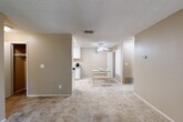 Located in Fair Oaks, CA, this well-appointed one-bedroom, one-bathroom unit offers a comfortable and efficient layout across a single floor. The open living area is finished with plush carpeting and neutral warm-toned walls, creating a welcoming atmosphere. A large picture window floods the space with natural light while framing pleasant views of surrounding mature trees, bringing a sense of the outdoors inside.

The kitchen is thoughtfully designed with crisp white cabinetry, granite-style countertops, tile flooring, and black appliances including a gas range, refrigerator, and dishwasher. A ceiling fan overhead and a skylight add to the bright, airy feel, while a dedicated dining area adjacent to the kitchen provides a convenient space for meals.

The bedroom is a comfortable retreat, featuring carpeted floors, a window for natural light, and sliding glass doors that open to a private balcony overlooking lush greenery. A closet provides ample storage within the room.

The bathroom is well-finished with a granite-topped vanity, white cabinetry, tile flooring, and a full tub-shower combination. Throughout the unit, the consistent use of neutral tones and quality finishes creates a cohesive and inviting living environment.