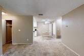 Located in Fair Oaks, CA, this well-appointed one-bedroom, one-bathroom unit offers a comfortable and efficient layout across a single floor. The open living area is finished with plush carpeting and neutral warm-toned walls, creating a welcoming atmosphere. A large picture window floods the space with natural light while framing pleasant views of surrounding mature trees, bringing a sense of the outdoors inside.

The kitchen is thoughtfully designed with crisp white cabinetry, granite-style countertops, tile flooring, and black appliances including a gas range, refrigerator, and dishwasher. A ceiling fan overhead and a skylight add to the bright, airy feel, while a dedicated dining area adjacent to the kitchen provides a convenient space for meals.

The bedroom is a comfortable retreat, featuring carpeted floors, a window for natural light, and sliding glass doors that open to a private balcony overlooking lush greenery. A closet provides ample storage within the room.

The bathroom is well-finished with a granite-topped vanity, white cabinetry, tile flooring, and a full tub-shower combination. Throughout the unit, the consistent use of neutral tones and quality finishes creates a cohesive and inviting living environment.