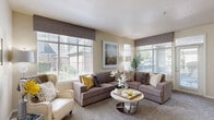 Located in South Jordan, Utah, this thoughtfully designed 2-bedroom, 2-bathroom single-story home offers a comfortable and functional layout. The bright, carpeted living room is a welcoming centerpiece, featuring multiple large windows that fill the space with natural light and offer views of the surrounding neighborhood. The open-concept layout connects the living area to a dedicated dining space, which flows seamlessly into the kitchen through a pass-through bar. The kitchen is equipped with stainless steel appliances, white cabinetry, tile flooring, and ample counter space. The spacious primary bedroom includes generous windows, plush carpet, and a walk-in closet with built-in wire shelving. Both bathrooms are well-appointed, with one featuring a full tub-shower combo, wood-look flooring, and bright white finishes. A dedicated in-unit laundry room accommodates a full-size washer and dryer. Additional highlights include two private patios, two closets, a utility room, and a welcoming entrance. The neutral color palette and warm finishes throughout contribute to a cohesive and inviting atmosphere from room to room.