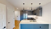 This contemporary 720 square foot apartment in Denver offers a thoughtfully designed living space. The open-concept layout seamlessly integrates the kitchen, living, and dining areas, creating a sense of spaciousness. Large windows flood the rooms with natural light, providing stunning urban views and enhancing the airy ambiance.

The kitchen is a highlight, featuring grey cabinetry, stainless steel appliances, and a functional island with a sink, perfect for meal preparation or casual dining. Pendant lights add a touch of modern elegance. The bathroom boasts a clean, minimalist design with a large vanity and ample storage.

The bedroom, measuring 150 square feet, offers a cozy retreat with ample space for a queen-sized bed and additional furniture. A walk-in closet provides generous storage options. Throughout the apartment, light wood-look flooring creates a warm, inviting atmosphere.

Attention to detail is evident in the crisp white walls, recessed lighting, and sleek ceiling fans. The apartment's single floor layout and efficient use of space make it an ideal urban dwelling for those seeking a stylish, low-maintenance lifestyle in the heart of Denver.