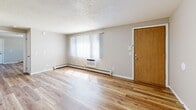 Located at 124 Capitol View Terr in Madison, WI, this one-bedroom, one-bathroom unit offers a practical and well-maintained single-floor layout. Throughout the space, light wood-tone flooring provides a clean, cohesive look that ties each room together.

The living room is a welcoming entry point, featuring a textured ceiling, neutral walls, baseboard heating, and a wall-mounted air conditioning unit. Natural light filters in through windows dressed with sheer vertical blinds, brightening the space throughout the day.

The kitchen is efficiently designed with white shaker-style cabinetry, black hardware accents, light stone-look countertops, a stainless steel sink, and stainless steel appliances including a range and refrigerator. A skylight overhead adds additional natural light to the workspace.

The bedroom offers a comfortable footprint with a large sliding-door closet, a window with horizontal blinds for natural light and privacy, and baseboard heating. The neutral color palette and wood flooring continue seamlessly from the rest of the unit.

The bathroom is clean and functional, featuring a white vanity with dark hardware, a shower-tub combination with a curtain rod, and matching wood-look flooring. The overall ambiance of the unit is bright, neutral, and move-in ready.