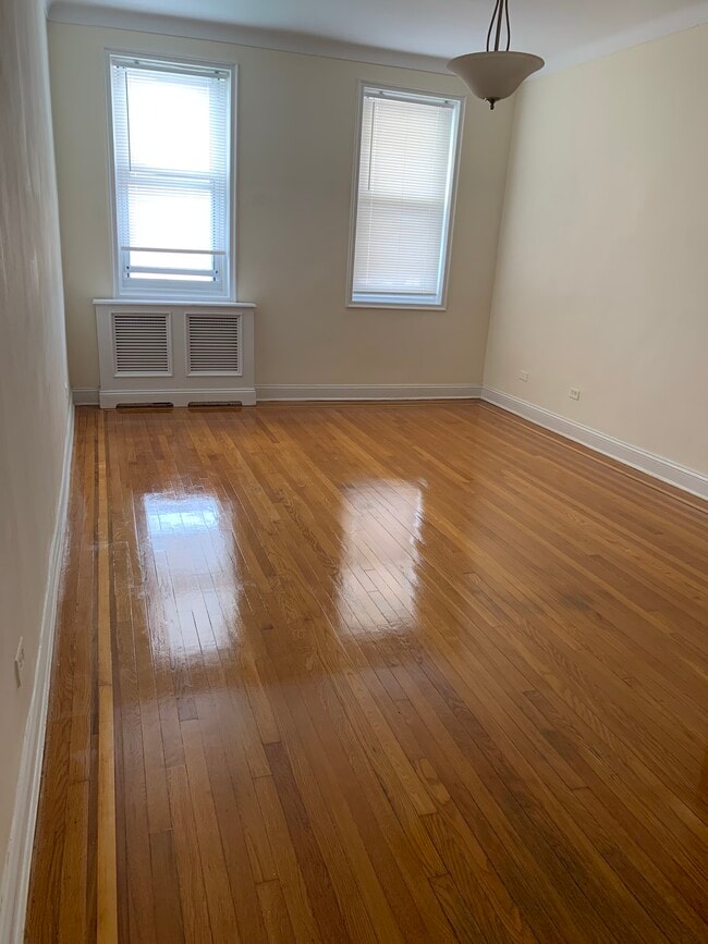 Living room with redone hardwood floors and custom radiator cover - 286 Corbin Plz