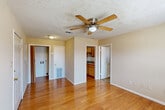Located at 1416 Delplaza Dr in Baton Rouge, Louisiana, this single-floor, one-bedroom, one-bathroom unit offers a practical and functional layout across a compact yet well-organized footprint. The living and dining areas share an open feel, finished with warm hardwood-style flooring and a textured ceiling with a ceiling fan overhead, lending a classic character to the space. Natural light filters in through slatted blinds, brightening the neutral, warm-toned walls throughout. The galley-style kitchen is efficiently arranged with wood-toned cabinetry on both sides, laminate countertops, a double basin sink, electric range, built-in dishwasher, and a full-size refrigerator — providing ample functionality in a compact corridor design. The bedroom is a comfortable retreat, featuring plush carpeting, dual windows that invite natural light, and a ceiling fan for added comfort. A dedicated closet offers convenient storage. The bathroom includes a single-sink vanity with wood cabinetry, a mirror, toilet, and a full shower-tub combination. A separate laundry area adds everyday convenience. This unit delivers a straightforward, no-frills living experience suited for those seeking practical accommodations in Baton Rouge.