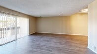 Located at 800 S Brea Blvd in Brea, California, this single-floor, 2-bedroom, 2-bathroom home offers a well-organized layout with a practical flow throughout. The living area features wood-style laminate flooring and a textured ceiling, with vertical blinds covering a sliding glass door that brings in natural light. The kitchen is equipped with white cabinetry, neutral countertops, a stainless steel range with an electric cooktop, a double-basin sink, and wood-style tile flooring, all brightened by a window with vertical blinds. A connecting hallway leads to the two bedrooms and bathrooms. The primary bedroom is generously sized with plush carpeting, neutral wall tones, and a closet, while the second bedroom also features carpet and ample wall space. Both bathrooms are finished consistently with wood-style flooring, white vanity cabinetry, neutral countertops, a large mirror with overhead lighting, and a separate water closet area. Each bedroom includes its own closet for added storage. Throughout the home, warm beige tones, clean white trim, and consistent finishes create a cohesive and functional living environment.