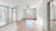This contemporary single-story residence offers 990 square feet of thoughtfully designed living space. The home features three bedrooms, including a spacious 160 square foot primary bedroom, and two well-appointed bathrooms. The open-concept layout creates a seamless flow between living areas, enhanced by large windows that flood the space with natural light.

The kitchen is a standout feature, boasting sleek white cabinetry, granite countertops, and modern stainless steel appliances. A central island with a sink provides additional prep space and casual seating. The living areas and bedrooms showcase beautiful hardwood flooring, adding warmth and elegance to the space.

The bathrooms are tastefully designed with granite vanity tops, modern fixtures, and a combination of tiled and hardwood flooring. Ample storage is provided throughout, including a walk-in closet with wire shelving systems.

Energy-efficient features include ceiling fans and recessed lighting. The property's exterior offers a glimpse of a well-maintained landscape, visible through the large windows. Located at 591 Jackie Moore LN in Canton, GA, this home combines modern design with practical living spaces, making it an ideal choice for those seeking contemporary comfort.