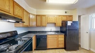 Located at 38 N Summit Dr in Gaithersburg, MD, this single-floor residence offers two bedrooms, one bathroom, and a practical, well-organized layout. The living area is generously sized, featuring warm beige carpet, a ceiling fan, and a large sliding glass door dressed with vertical blinds that invites abundant natural light and provides access to the outdoors. The space flows openly, creating a comfortable and airy atmosphere throughout.

The kitchen is efficiently designed with warm oak cabinetry extending to the upper walls, dark granite-style countertops, tile flooring, and a full suite of black appliances including a refrigerator, dishwasher, electric range, and overhead ventilation. A window near the kitchen provides additional natural light to the cooking area.

The spacious primary bedroom is carpeted and bathed in natural light through a large window with vertical blinds. The second bedroom is equally bright and comfortable, also featuring soft carpet and a window. Two closets provide practical storage throughout the unit.

The bathroom is clean and classic, featuring a full tub-shower combination with white tile surround, a single-sink vanity with wood cabinetry, and white tile flooring. A hallway connects the key areas of the home, contributing to a cohesive and functional flow throughout the residence.