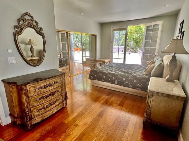 Master bedroom with outdoor balcony and French doors. - 1663 Malcolm Ave