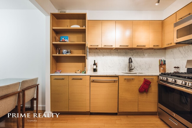 Sizable fully-equipped kitchen with extra-room for a dining table. - 100 W 39th St