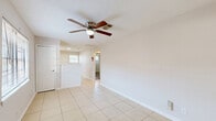 Located at 3603 Alice Street in Houston, TX, this single-story home offers a practical and well-organized layout across three bedrooms, one bathroom, a living room, kitchen, hallway, and two closets. The interior features a neutral color palette throughout, creating a clean and cohesive look.

The living room is finished with light ceramic tile flooring and includes a ceiling fan with a window allowing natural light to filter in. It connects directly to the front entry, providing a welcoming first impression. The kitchen is equipped with white cabinetry, granite-style countertops, a stainless steel sink, a tile backsplash, and a stainless steel refrigerator, all set atop matching light tile flooring. A window above the sink brings in additional natural light.

The three bedrooms feature light wood-look laminate flooring and ceiling fans. The primary bedroom benefits from dual windows that invite generous natural light and outdoor views of surrounding greenery. The additional bedrooms are well-proportioned and versatile. One bedroom is finished with tile flooring, while the others feature the laminate wood finish.

The bathroom includes a full tub-shower combination, toilet, and a window for ventilation. The overall ambiance of the home is clean, functional, and move-in ready, suited for comfortable everyday living.