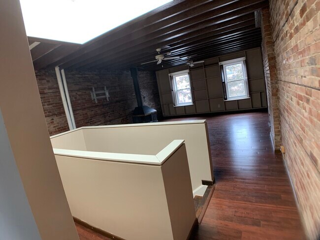 Large living area with custom, wall-to-wall bookshelves - 182 N Pearl St