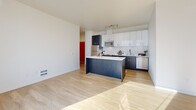 Located in Seattle's Queen Anne neighborhood, this well-designed one-bedroom, one-bathroom residence offers a thoughtful layout across a single floor. Light wood flooring runs throughout, creating a cohesive and contemporary feel.

The open-concept living, dining, and kitchen area forms the heart of the home. The kitchen is outfitted with stainless steel appliances, including a full-size refrigerator, range, microwave, and dishwasher. A two-tone cabinetry scheme pairs dark lower cabinets with crisp white upper cabinets, complemented by a classic subway tile backsplash and a central island with a white countertop—ideal for dining or meal prep. Track lighting accents the space above.

Large windows allow generous natural light to pour into the living area, which opens directly onto a private balcony. The bedroom is a bright, comfortable retreat featuring a ceiling fan, a tall window, a sliding-door closet, and access to additional natural light. A second closet with wire shelving provides additional storage.

The bathroom is clean and functional with wood-tone flooring. A dedicated laundry area and a hallway connecting the main spaces complete this efficient, modern floor plan—well-suited for urban living in Seattle.