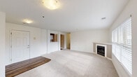 Located at 1165 Tall Grass Cir in Stow, Ohio, this single-floor, 2-bedroom, 2-bathroom home offers a well-designed layout with modern finishes throughout. The spacious living room is a standout, featuring soft carpeting, large windows that invite generous natural light, and a classic wood-burning fireplace with a clean white mantel — creating a warm and inviting atmosphere. A private balcony extends the living space outdoors, ideal for relaxing.

The kitchen is thoughtfully appointed with white shaker-style cabinetry, granite-look countertops, wood-look flooring, and a full suite of stainless steel appliances including a range, microwave, and refrigerator. An adjacent dedicated laundry room adds everyday convenience.

Both bathrooms are finished with granite-topped white vanities, wood-look flooring, and brushed nickel fixtures. The primary bedroom is generously sized with multiple windows offering outdoor views and plush carpeting underfoot. The second bedroom also features carpeting, a closet, and ample natural light.

With four closets spread throughout, the home provides excellent storage. The clean, neutral palette and updated finishes give the entire space a bright, move-in-ready feel.