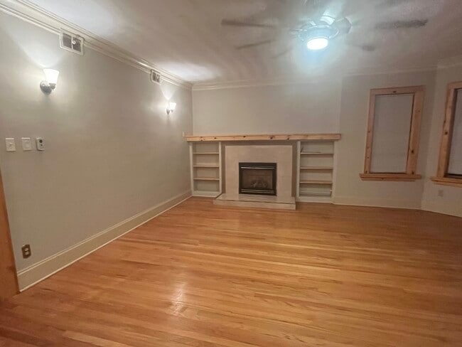 Gas burning fireplace with mantle and shelving. - 7619 S Phillips Ave