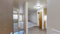 Located at 13960 Lakeside Blvd N in Shelby Township, Michigan, this one-bedroom, one-bathroom unit offers a thoughtfully organized single-floor layout designed for comfortable everyday living. The open entryway leads directly into a functional kitchen equipped with warm oak cabinetry, granite-style countertops, a white electric range, refrigerator, dishwasher, and a built-in microwave. A door off the kitchen provides convenient access to an in-unit laundry area with a stacked washer and dryer. Wood-look plank flooring runs throughout the kitchen and main living area, creating a clean, cohesive look. The living space is bright and airy, benefiting from natural light through a large window with views of surrounding greenery. The bedroom offers a comfortable footprint, soft carpeting underfoot, and a full-size closet with bifold doors for ample storage. The bathroom is finished with light tile flooring, a vanity with warm wood cabinetry, a soaking tub, and a tiled shower surround. Neutral tones throughout the unit provide a versatile backdrop, making the space easy to personalize. This well-appointed unit delivers practical amenities and a clean, move-in-ready aesthetic in a residential Shelby Township setting.
