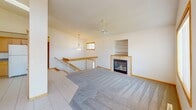 Located in Rochester, Minnesota, this two-story home at 112 Avalon Cove Cir NW offers a well-designed layout with thoughtful architectural details throughout. The main living area is anchored by a cozy fireplace framed with tile surround and a built-in shelving unit, complemented by plush carpeting, a ceiling fan, and an open staircase with white balusters. An elegant chandelier and pendant lighting add warm character to the home.

The dining area impresses with soaring vaulted ceilings, large transom windows that flood the space with natural light, and sliding glass doors that open directly onto a private outdoor deck. Light-toned tile flooring flows through this area and into the kitchen, which features warm honey-toned cabinetry with glass-front upper doors, granite-style countertops, a peninsula with sink, and ample storage.

The bedrooms are carpeted and well-lit, each with windows offering outdoor views and ceiling fans for comfort. The bathrooms are finished with tile flooring, oak cabinetry, and clean white fixtures, including a full tub-shower and a separate walk-in shower. Throughout the home, warm wood trim and neutral tones create a cohesive and inviting ambiance suited for comfortable everyday living.