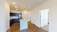 Located at 1016 Lavon Dr in Garland, Texas, this single-story space offers a well-designed, open layout that maximizes functionality throughout. The kitchen serves as a central highlight, featuring rich dark-brown cabinetry with ample upper and lower storage, light countertops, and a full suite of black appliances including a refrigerator, range, and built-in microwave. A central kitchen island with an integrated sink and pendant lighting above provides additional workspace and a natural gathering point within the open living area.

Wood-style hard flooring extends throughout the main living and kitchen areas, lending warmth and continuity to the space. Recessed lighting and natural light from windows contribute to a bright, welcoming atmosphere. The layout also reveals ceiling fans in the living area, enhancing comfort year-round.

The bedroom offers a quieter retreat, finished with plush carpet flooring and a window with blinds that allows natural light while maintaining privacy. The bathroom includes a full soaking tub and shower combination with clean white tile surround and chrome fixtures, providing a simple and functional design. Overall, the space presents a practical and cohesive interior suited for comfortable everyday living.