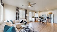Located in Tolleson, Arizona, this thoughtfully designed one-bedroom, one-bathroom residence offers a functional and modern single-floor layout. Light wood-style flooring flows seamlessly throughout, lending warmth and visual continuity to every room.

The open-concept living and kitchen area serves as the heart of the home. The living room is bathed in natural light through multiple windows dressed with stylish patterned curtains and wood blinds, complemented by a ceiling fan overhead. The kitchen is well-appointed with crisp white shaker cabinetry, dark countertops, a full suite of stainless steel appliances including a refrigerator, range, microwave, and dishwasher, and a window above the sink for added brightness.

The entrance welcomes residents with a clean, airy foyer featuring neutral tones and recessed lighting that sets a calm tone for the rest of the home. The bedroom is a serene retreat, offering natural light through a window with decorative curtains, a ceiling fan, and access to a dedicated closet for ample storage.

The bathroom is finished with white cabinetry, dark countertops, wood-look flooring, and includes accessibility-friendly grab bars, reflecting both style and practicality. Every detail of this residence has been crafted to deliver comfort and functionality.